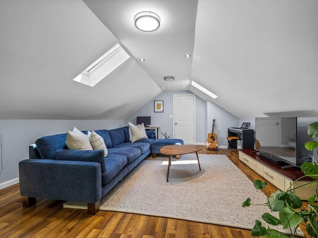 living area featuring a skylight, lofted ceiling, wood finished floors, and baseboards