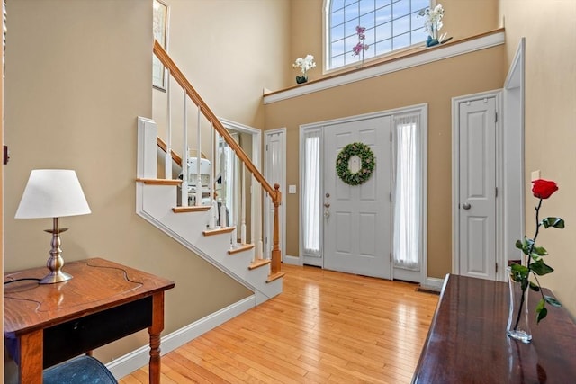 1 Cottonwood Cir, Kingston, NH 03848 - foyer entrance with a towering ceiling, stairway, hardwood / wood-style floors, and baseboards
