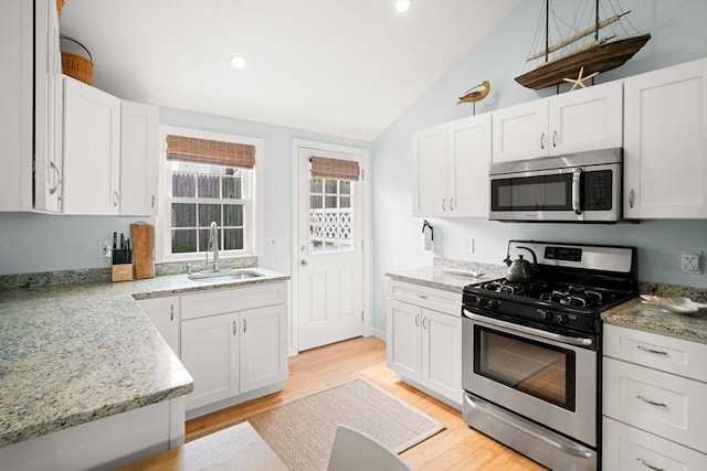 90 Broadway St Unit 90, Yarmouth, MA 02673 - kitchen featuring appliances with stainless steel finishes, a sink, vaulted ceiling, white cabinets, and recessed lighting