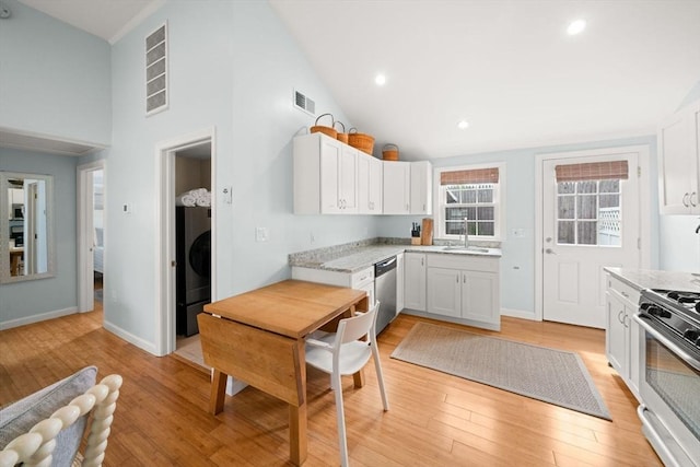 90 Broadway St Unit 90, Yarmouth, MA 02673 - kitchen with a sink, appliances with stainless steel finishes, high vaulted ceiling, white cabinetry, and light wood-style flooring
