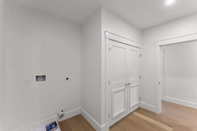 134 Court St Unit 2, Plymouth, MA 02360 - clothes washing area featuring hookup for an electric dryer, light wood-style flooring, baseboards, and hookup for a washing machine