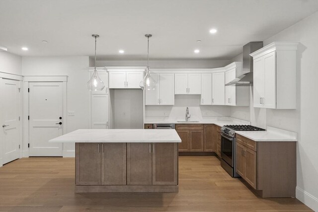 134 Court St Unit 2, Plymouth, MA 02360 - kitchen featuring a sink, light wood-style flooring, wall chimney exhaust hood, and stainless steel range with gas cooktop
