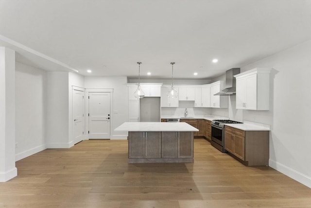 134 Court St Unit 2, Plymouth, MA 02360 - kitchen with baseboards, wall chimney range hood, recessed lighting, stainless steel gas range oven, and a kitchen island