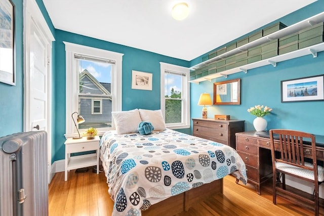 36-38 Rice St Unit 3, Cambridge, MA 02140 - bedroom featuring radiator heating unit and wood-type flooring