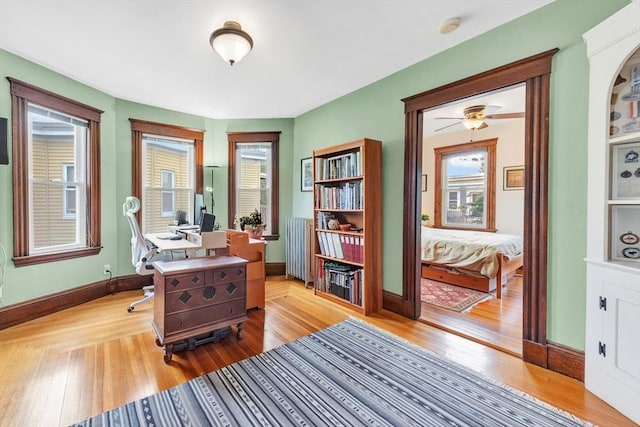 36-38 Rice St Unit 3, Cambridge, MA 02140 - office space with radiator heating unit, wood finished floors, and ceiling fan