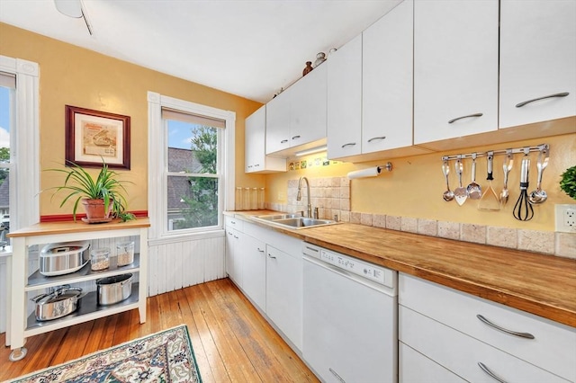 36-38 Rice St Unit 3, Cambridge, MA 02140 - kitchen with white dishwasher, white cabinets, light wood-type flooring, light countertops, and a wainscoted wall