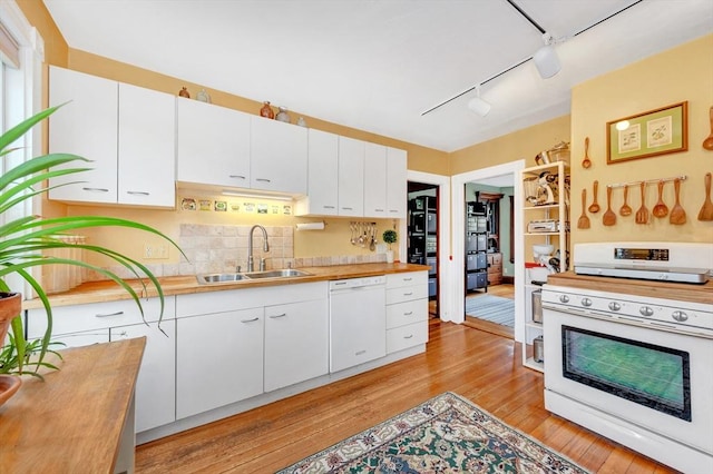 36-38 Rice St Unit 3, Cambridge, MA 02140 - kitchen featuring white appliances, track lighting, light wood finished floors, wooden counters, and white cabinetry