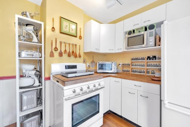 36-38 Rice St Unit 3, Cambridge, MA 02140 - kitchen with white appliances, white cabinets, wooden counters, and wood finished floors