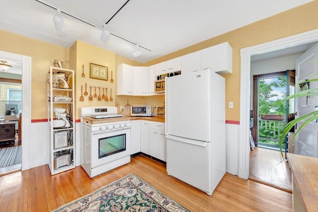 36-38 Rice St Unit 3, Cambridge, MA 02140 - kitchen with white appliances, track lighting, wainscoting, light wood-style flooring, and white cabinets