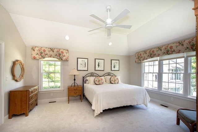 bedroom featuring visible vents, light carpet, baseboards, and vaulted ceiling