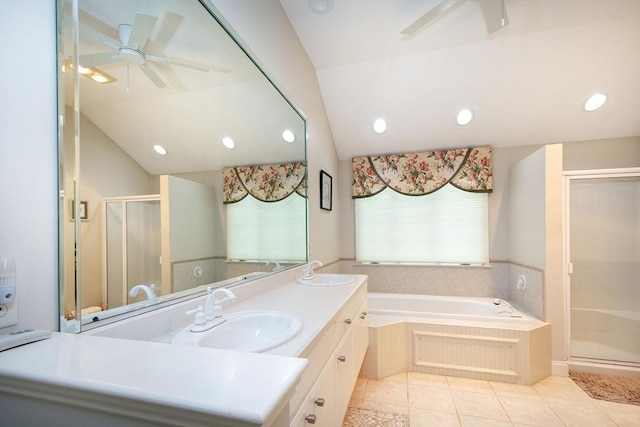 full bath with tile patterned floors, vaulted ceiling, a shower stall, and a sink