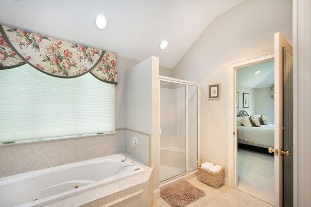 bathroom featuring a shower stall, a jetted tub, lofted ceiling, ensuite bathroom, and tile patterned floors