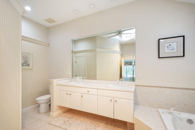 bathroom featuring tile patterned floors, double vanity, toilet, and a sink