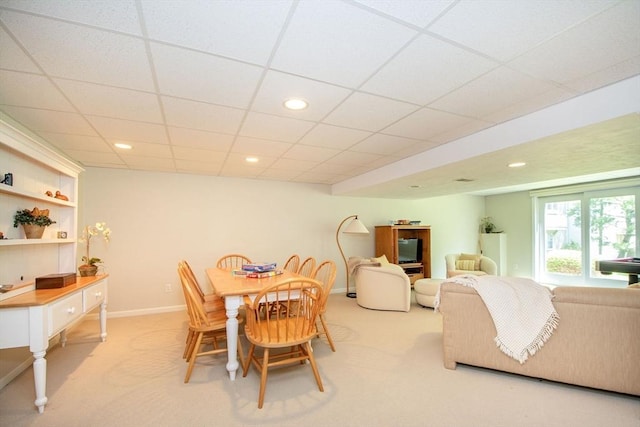 dining room with recessed lighting, light colored carpet, and baseboards