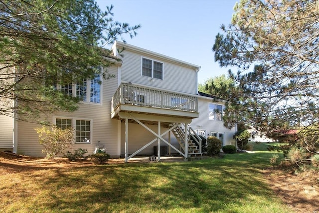 back of house featuring stairway, cooling unit, a lawn, and a deck