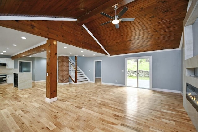 unfurnished living room with a tile fireplace, stairway, and baseboards