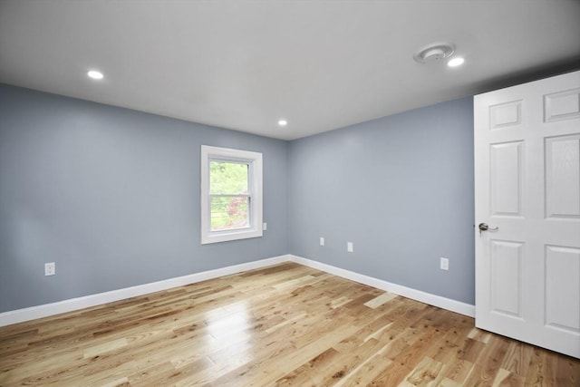 unfurnished room featuring light wood-type flooring, recessed lighting, and baseboards