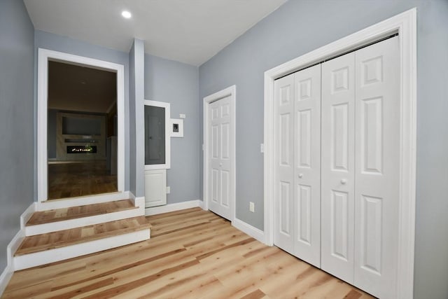 interior space featuring recessed lighting, baseboards, and light wood-style floors