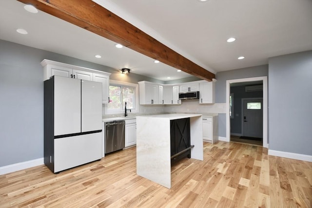 kitchen featuring white cabinets, stainless steel appliances, light countertops, and recessed lighting