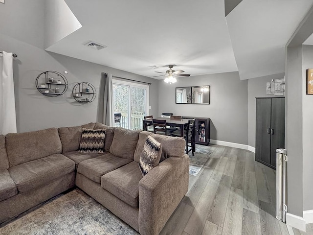 living room with hardwood / wood-style flooring and ceiling fan