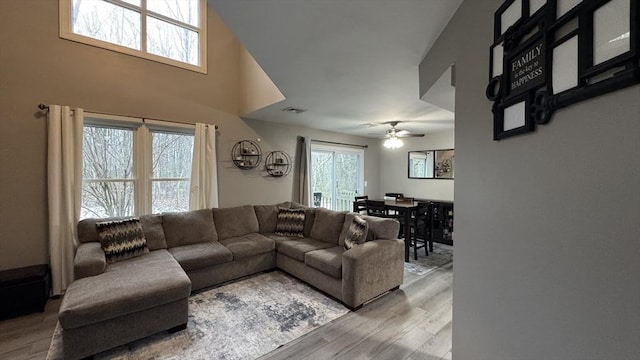 living room with hardwood / wood-style floors and ceiling fan