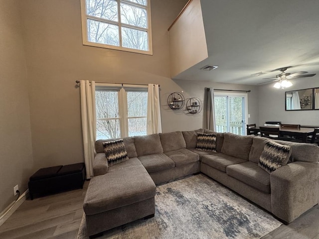 living room with wood-type flooring and ceiling fan