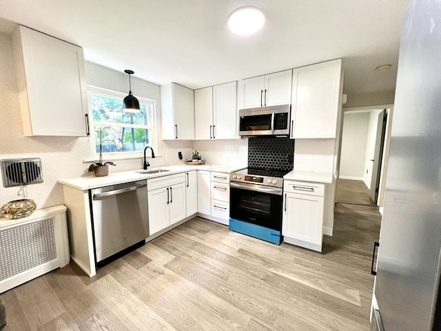 3 Rosewood Dr, Worcester, MA 01602 - kitchen featuring appliances with stainless steel finishes, white cabinets, light countertops, and decorative backsplash