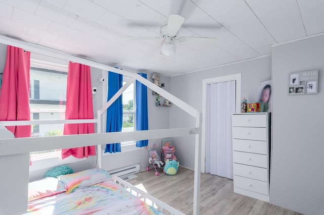 14 Sutton Ave, Oxford, MA 01540 - bedroom featuring a baseboard heating unit, wood finished floors, and ceiling fan