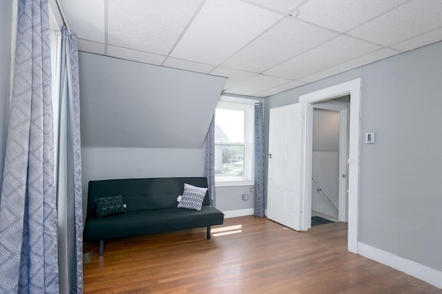 14 Sutton Ave, Oxford, MA 01540 - living area with a drop ceiling, wood finished floors, and baseboards