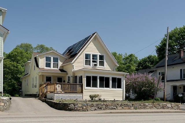 14 Sutton Ave, Oxford, MA 01540 - view of front of house featuring roof mounted solar panels and a wooden deck