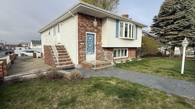 split foyer home with a chimney and brick siding