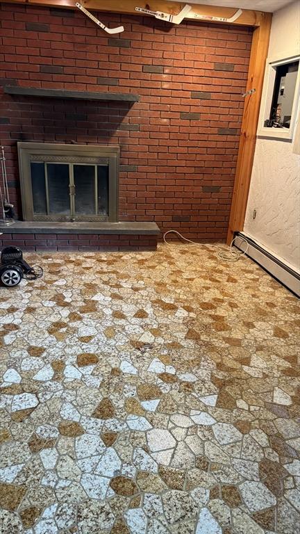 empty room featuring a glass covered fireplace