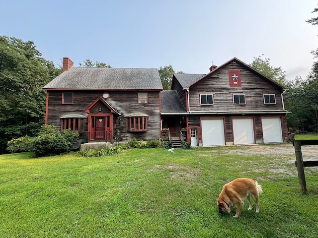 view of front of house featuring a garage and a front yard