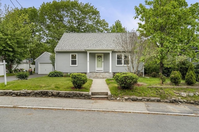 5 Walker Ave, Andover, MA 01810 - bungalow-style house featuring a detached garage, an outdoor structure, a front lawn, a shingled roof, and driveway