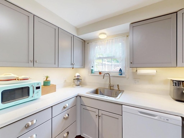 252 W St Unit 18, Amherst, MA 01002 - kitchen with white appliances, a sink, gray cabinets, and light countertops