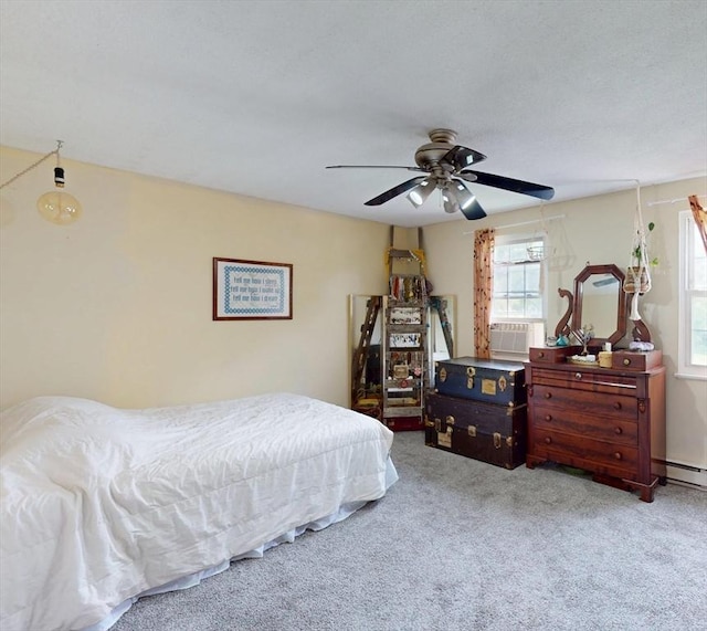 252 W St Unit 18, Amherst, MA 01002 - bedroom with multiple windows, carpet floors, a baseboard radiator, and a ceiling fan