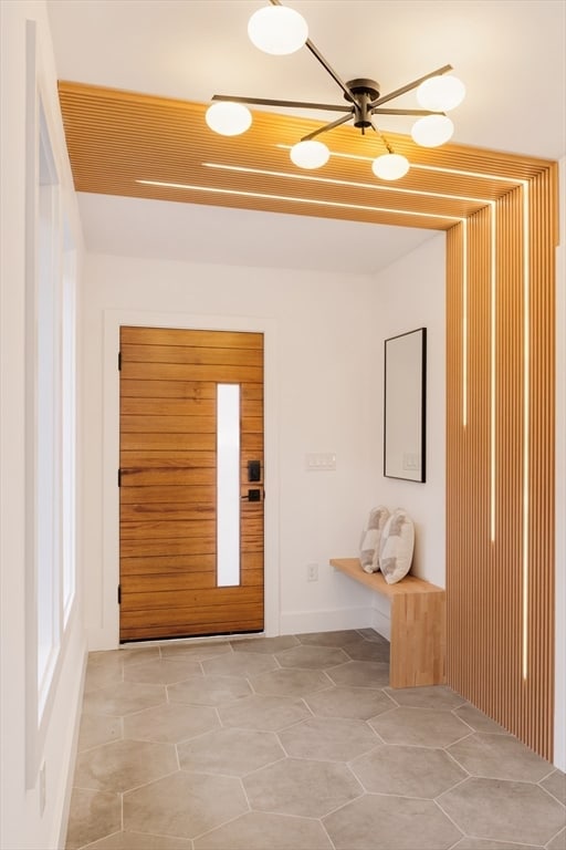 doorway to outside with light tile patterned flooring and ceiling fan