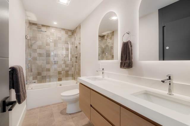 full bathroom featuring toilet, vanity, tile patterned flooring, and shower / bath combination with glass door