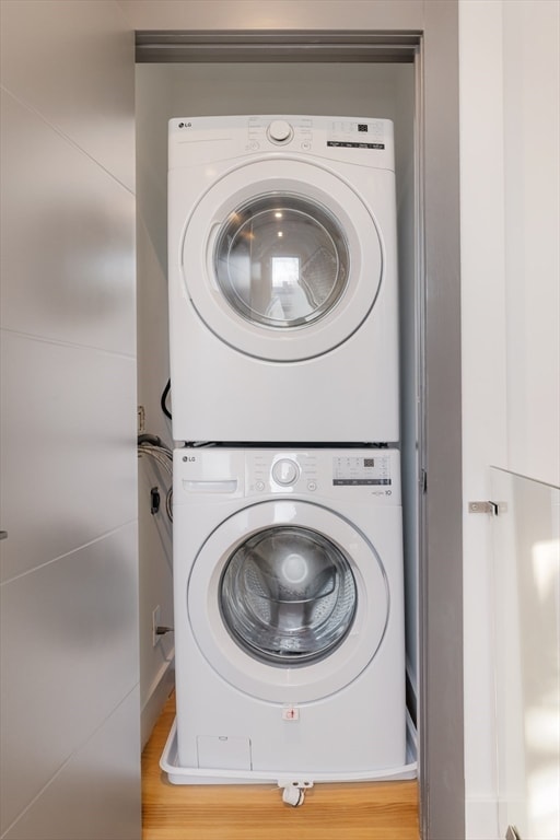 washroom featuring stacked washer / dryer