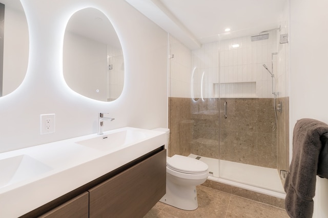 bathroom featuring tile patterned flooring, an enclosed shower, vanity, and toilet