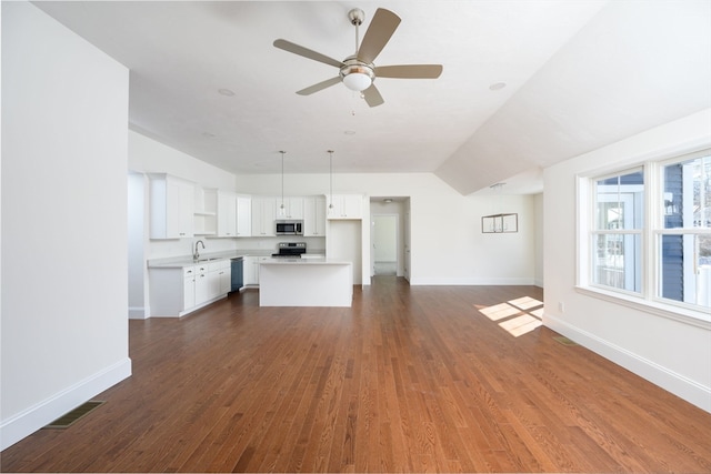 unfurnished living room with dark wood-type flooring and ceiling fan