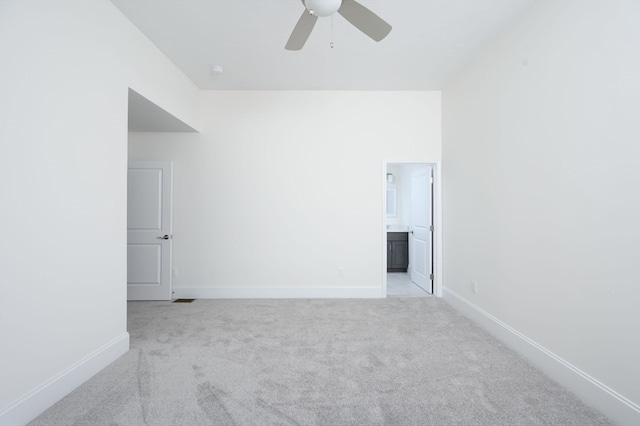 empty room with light colored carpet and ceiling fan