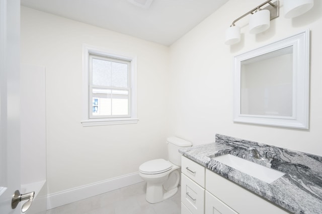 bathroom with tile flooring, toilet, and vanity