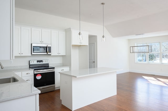 kitchen with hanging light fixtures, dark hardwood / wood-style flooring, white cabinets, and appliances with stainless steel finishes