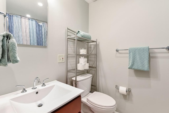 full bathroom featuring vanity and toilet