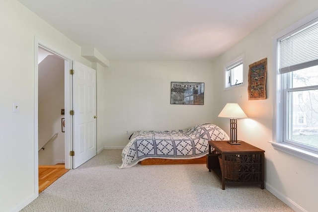 bedroom featuring baseboards and carpet