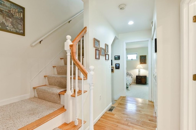 staircase featuring baseboards, recessed lighting, wood finished floors, and visible vents