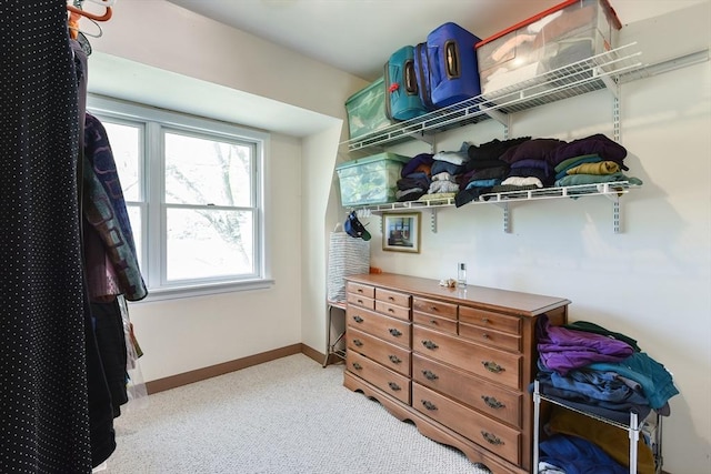 spacious closet featuring light colored carpet