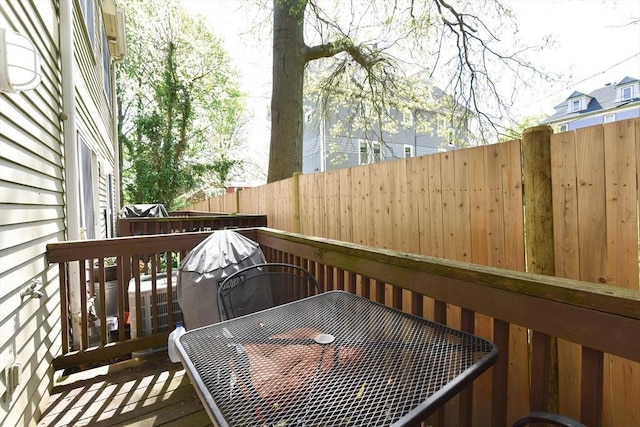 wooden terrace featuring fence and outdoor dining space