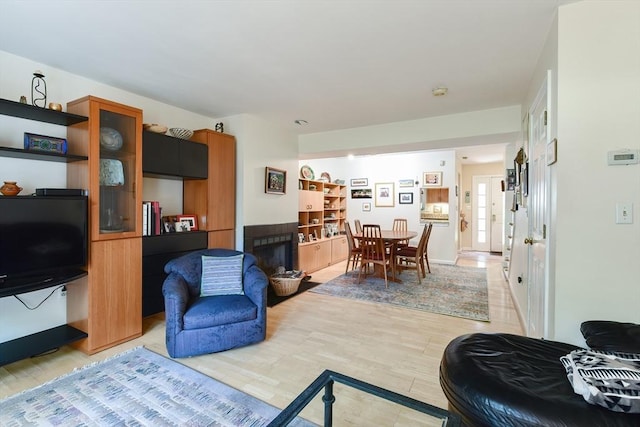 living room with light wood-type flooring and a fireplace